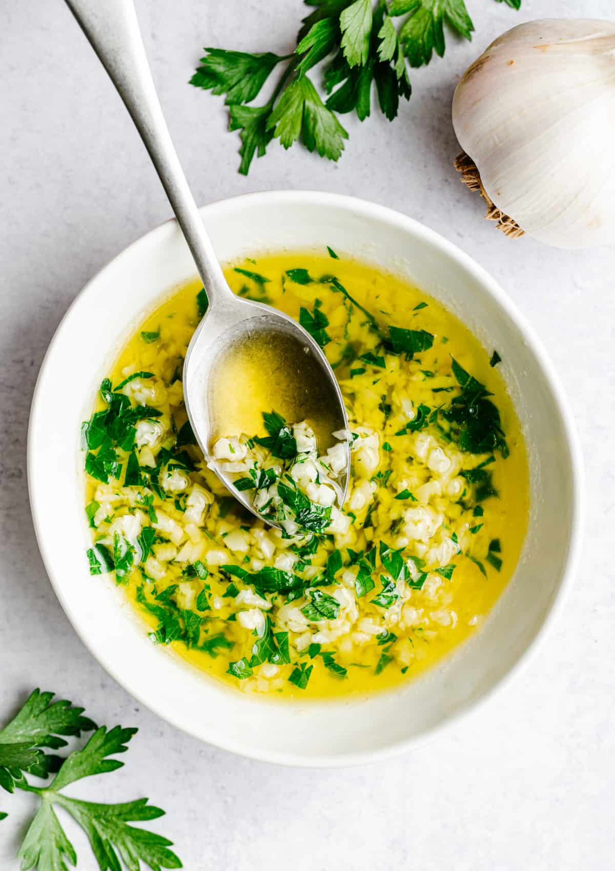 Savory homemade garlic sauce with herbs in a bowl