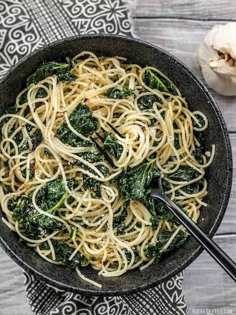 Garlic parmesan pasta with kale in a black bowl