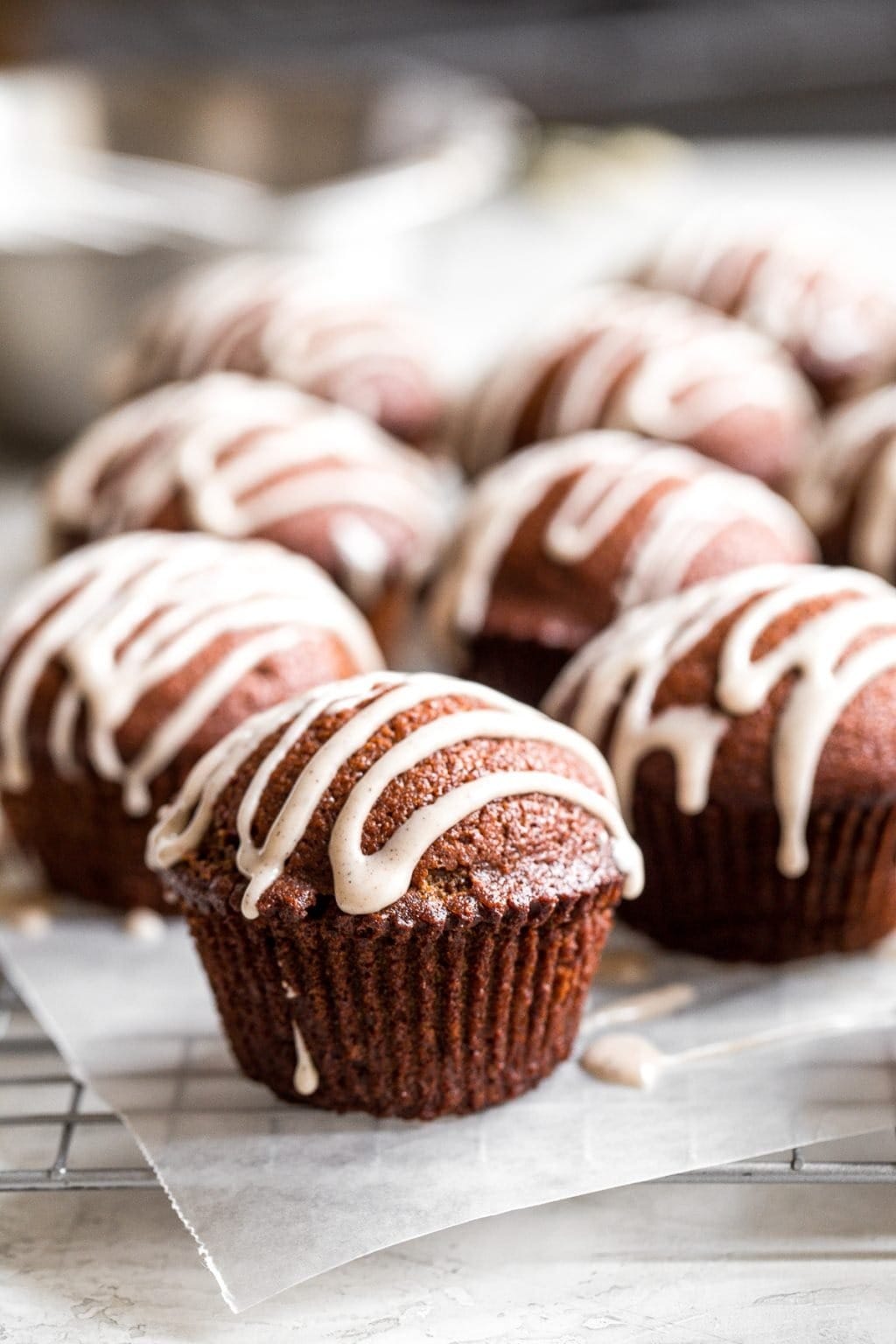 Bunch of gingerbread muffins drizzled with sugar glaze.
