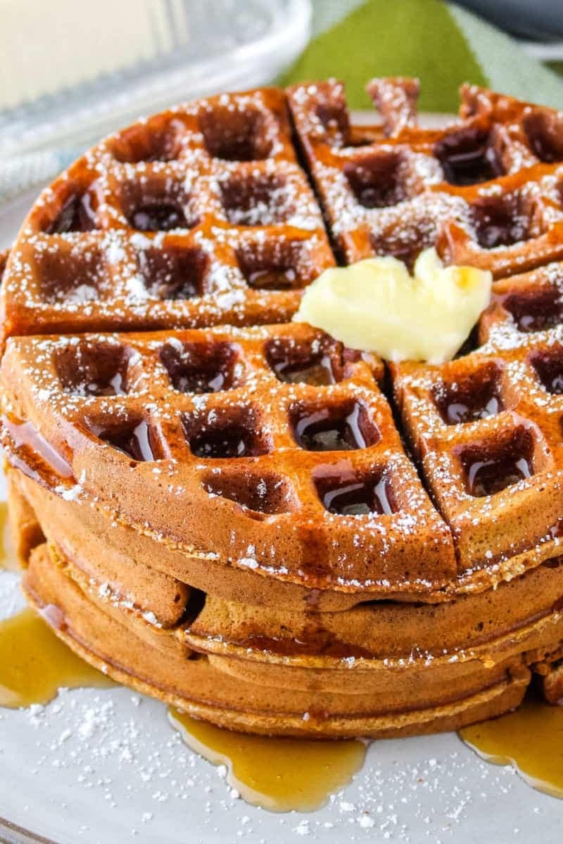 Gingerbread waffles with  maple syrup and butter dusted with powdered sugar. 