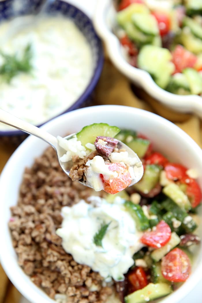 Healthy Greek Bowl with Ground Beef, Tomatoes, Cucumbers, Feta Cheese, and Yogurt Dill Sauce