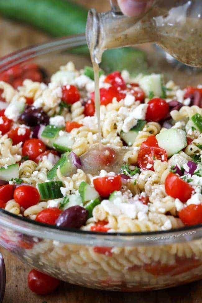 Bowl of Greek Pasta Salad with tender pasta, ripe juicy tomatoes, crisp cucumbers, feta cheese and olives