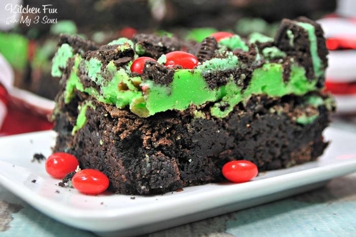 Bar of brownie topped  with green ganache and M&Ms. 
