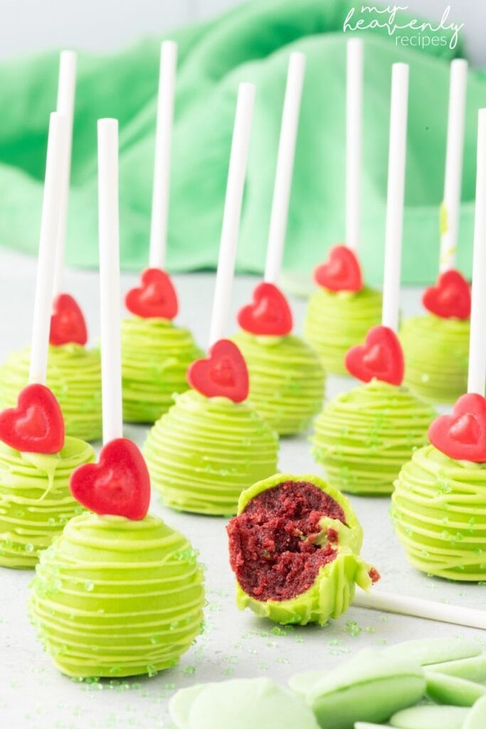 Chocolate cake pops on stick coated with green colored melted chocolate.