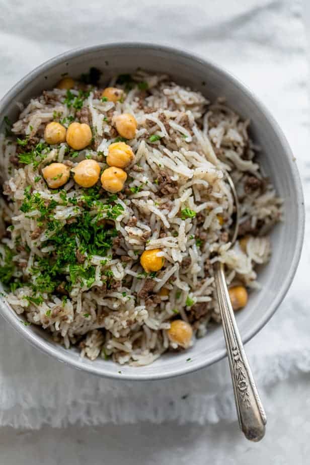 Mediterranean Ground Beef and Rice with Parsley and Chickpeas in a Bowl with a Spoon.