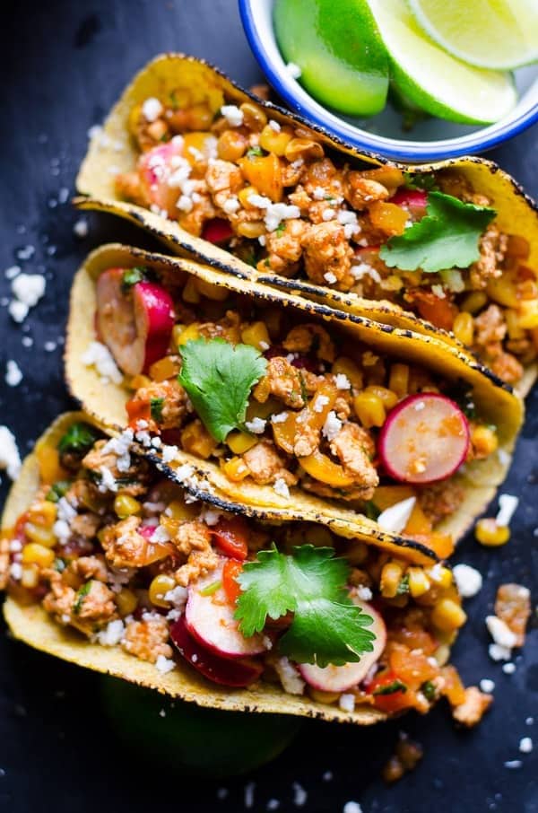 tacos with ground chicken, veggies and cheese filling.