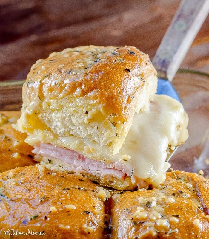 Brioche buns filled with sliced ham, Swiss Cheese, and Hawaiian rolls, smothered with a garlic Dijon butter sauce