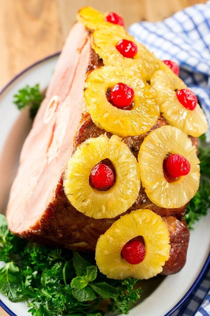 Whole ham with pineapple rings and cherries garnish.