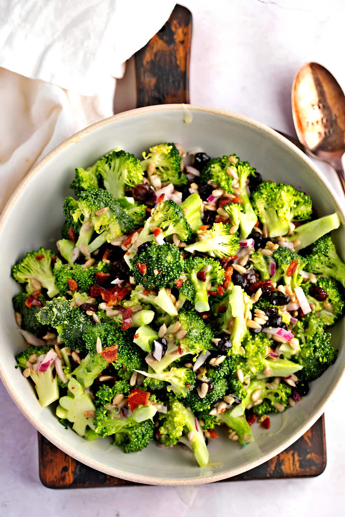 Top View of Healthy and Crunchy Broccoli Raisin salad with Sesame Seeds, Bacon, Onions, and Creamy Dressing in a Bowl
