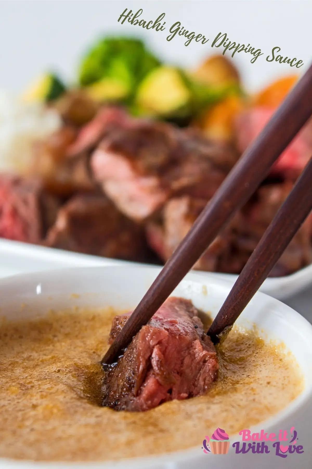 A person dipping a steak into a bowl of hibachi ginger sauce