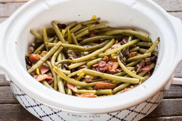 Green beans cooked in casserole with mushroom, bacon and sauce.