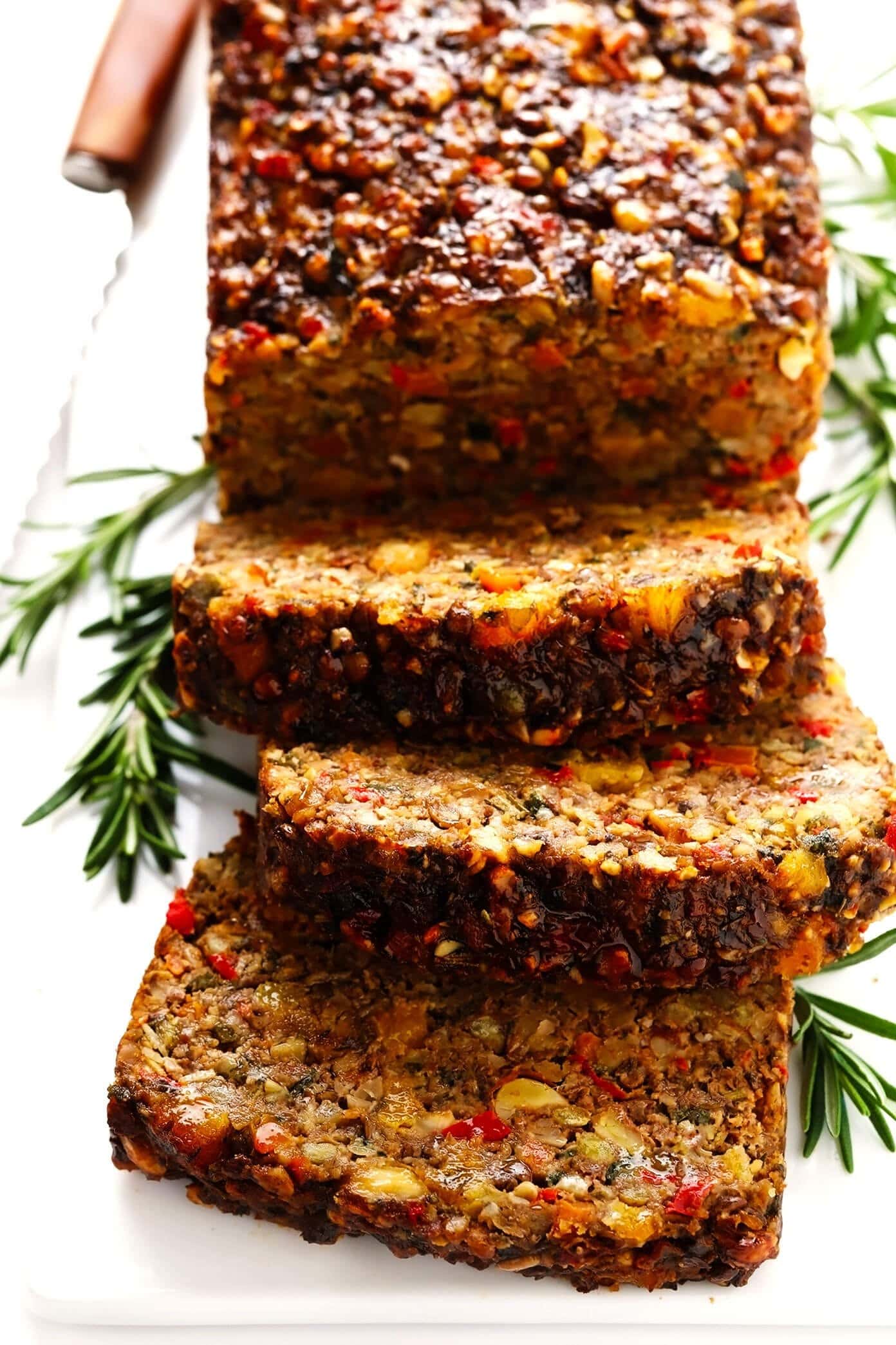 Sliced nut roast loaf made with chopped nuts, veggies and lots of herbs.