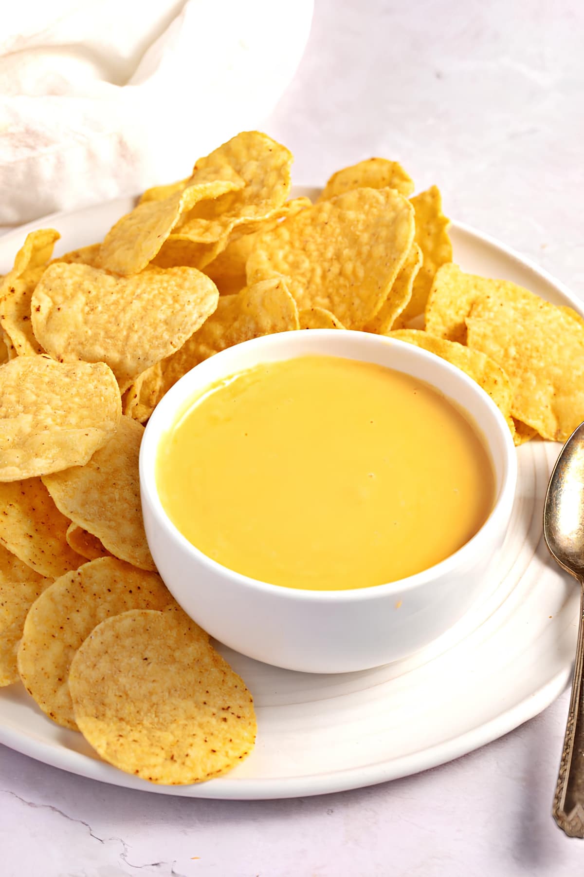 Appetizing Nacho Cheese Sauce in a Bowl with Served with Crunchy Chips