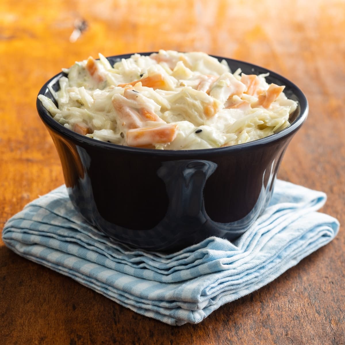 Creamy Coleslaw with Carrots and Cabbage on a Blue Napkin