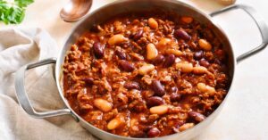 A delicious cowboy beans dish simmering in a pan, filled with flavorful spices and tender meat