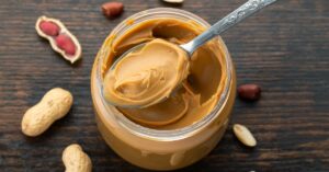 Homemade Peanut Butter in a Jar on a Wooden Table