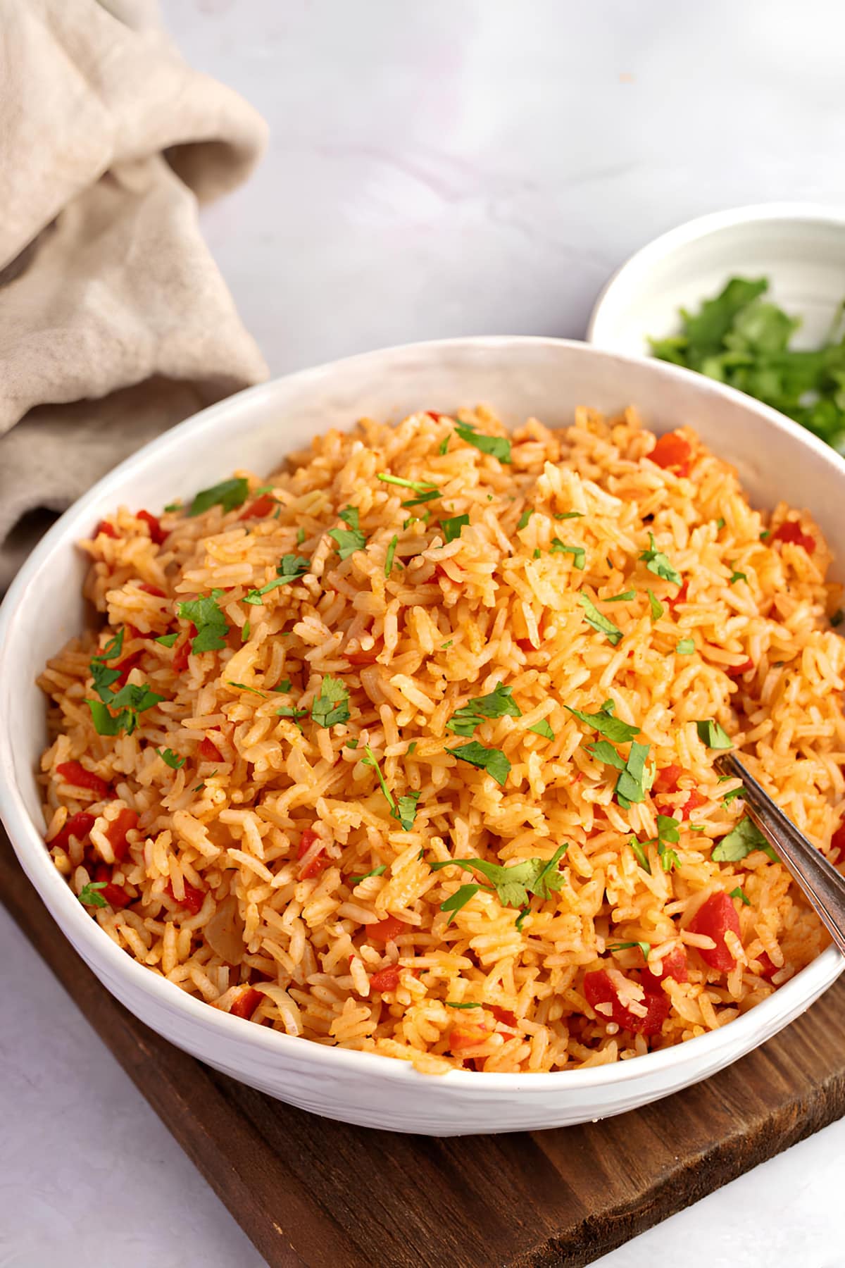 Spanish Rice: A delicious dish of fluffy rice cooked with savory spices and colorful vegetables, served in a traditional bowl