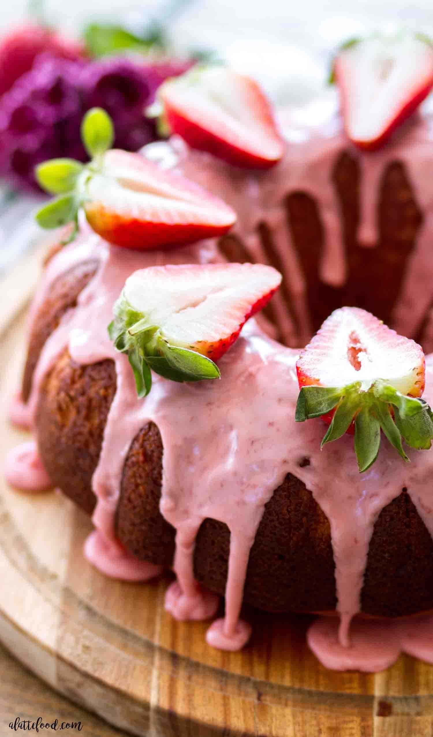 Chocolate bundt cake topped with fresh strawberry and glaze. 