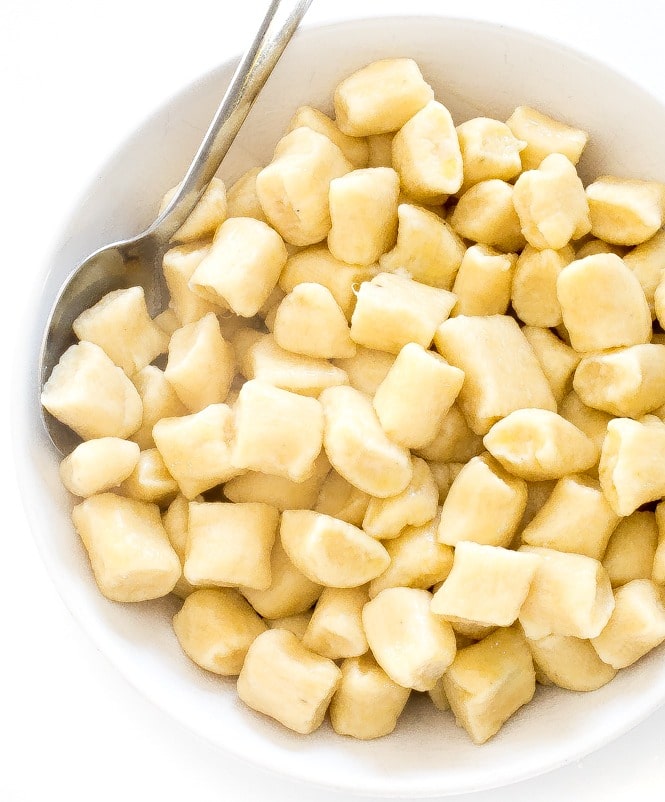 Bowl of potato gnocchi with spoon. 