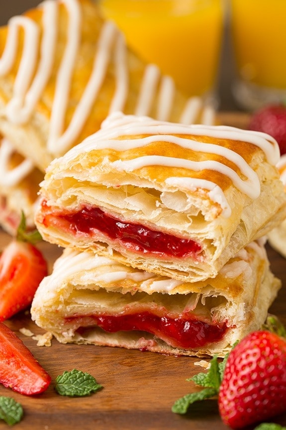 Cut in to halves toasted strudel with strawberry jam feeling stacked on each other