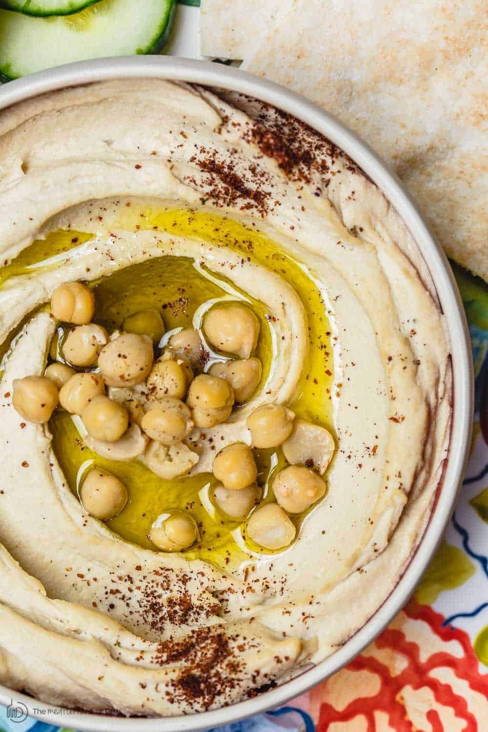 Top view of a bowl of Hummus with chickpeas on top