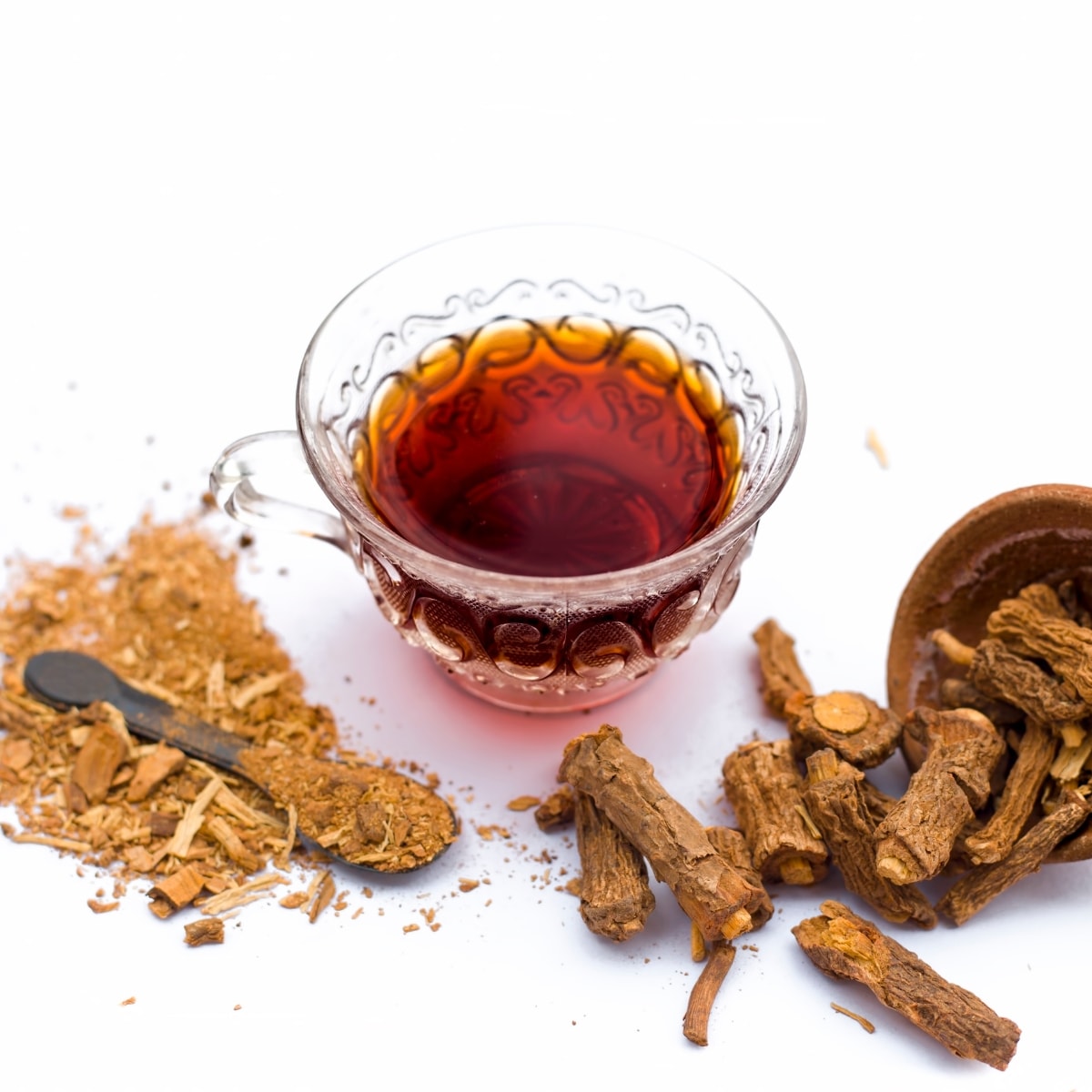 Dried Sarsaparilla with its Syrup and Powder on a White Background