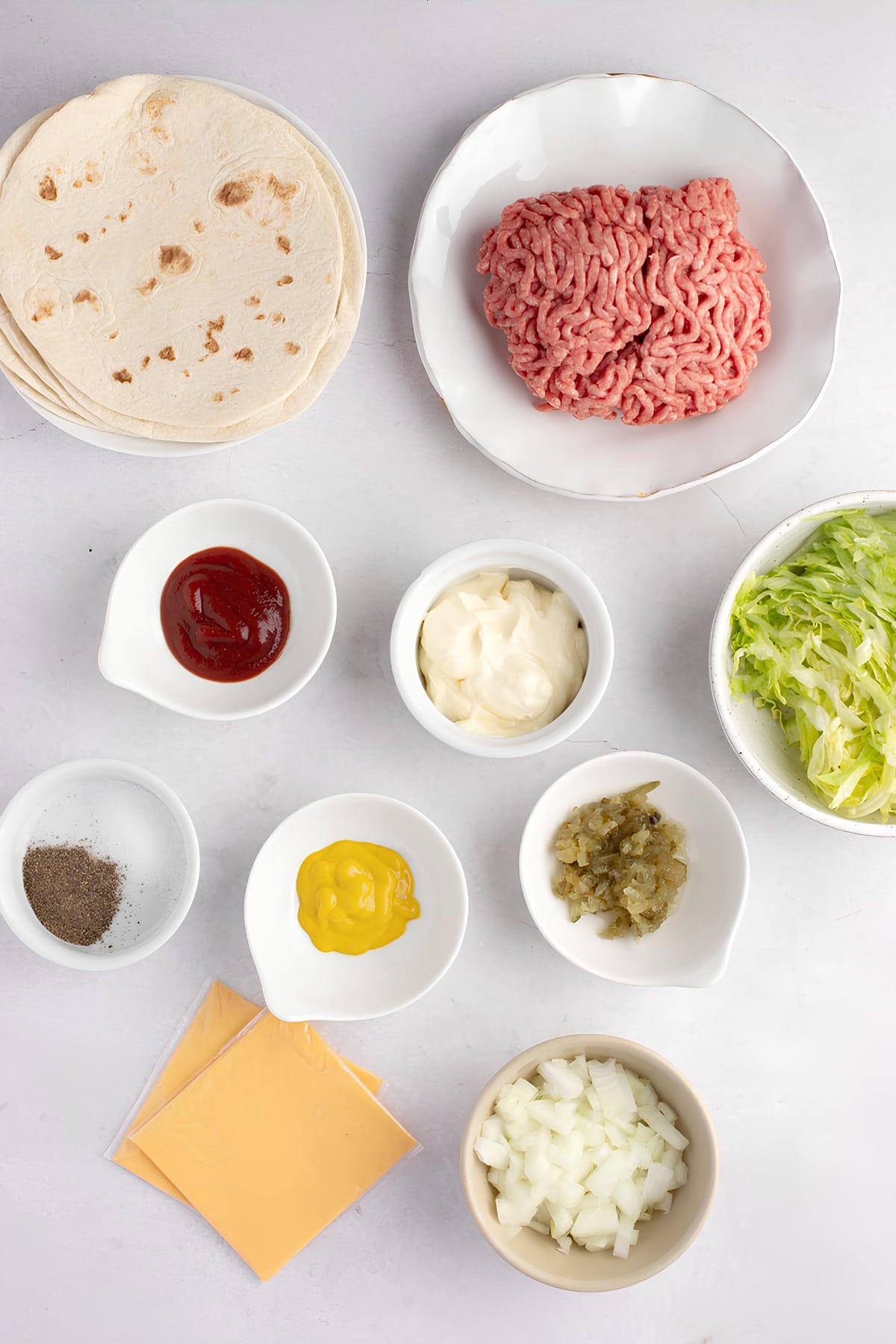 Smash Burger Taco Ingredients - Sauce, Ground Round, Seasoning, Flour Tortillas, Cheese, Lettuce and Onions