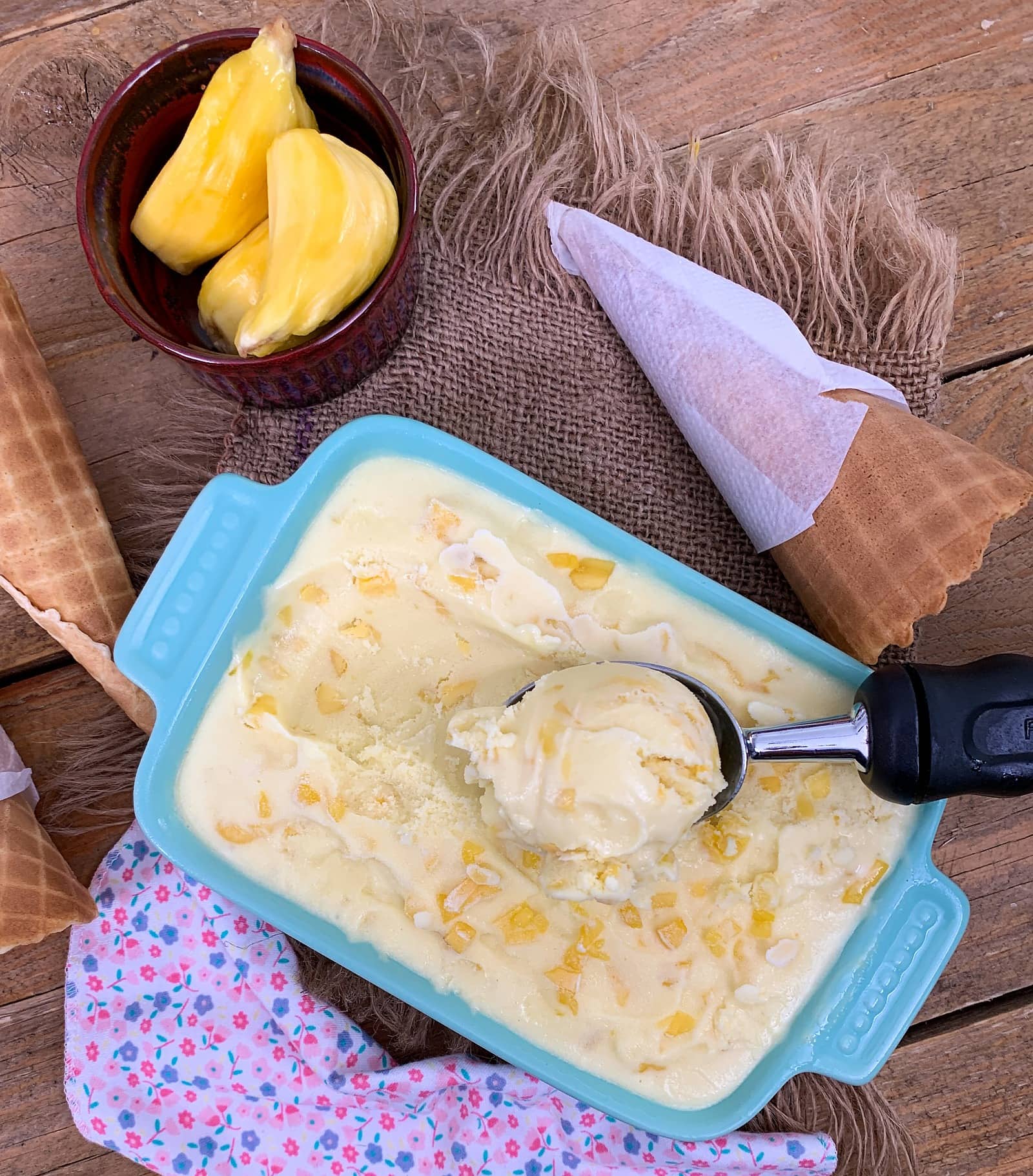 jackfruit ice cream in a blue pan with scooper.
