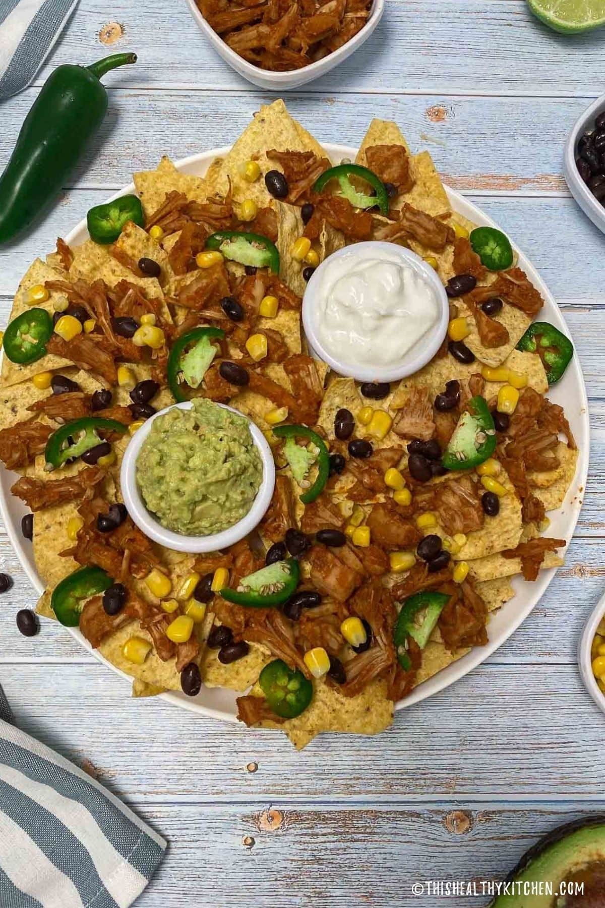 Nachos with jackfruit, corn and beans with sauce.