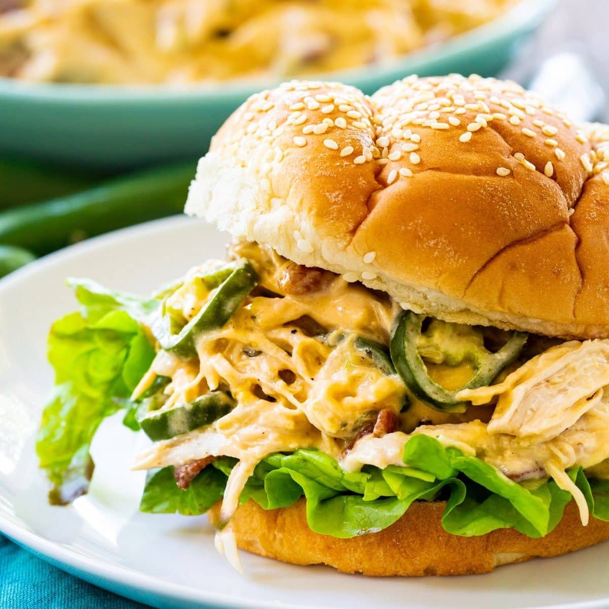 Buns with shredded chicken, jalapenos, lettuce, ranch, and cheese filling.
