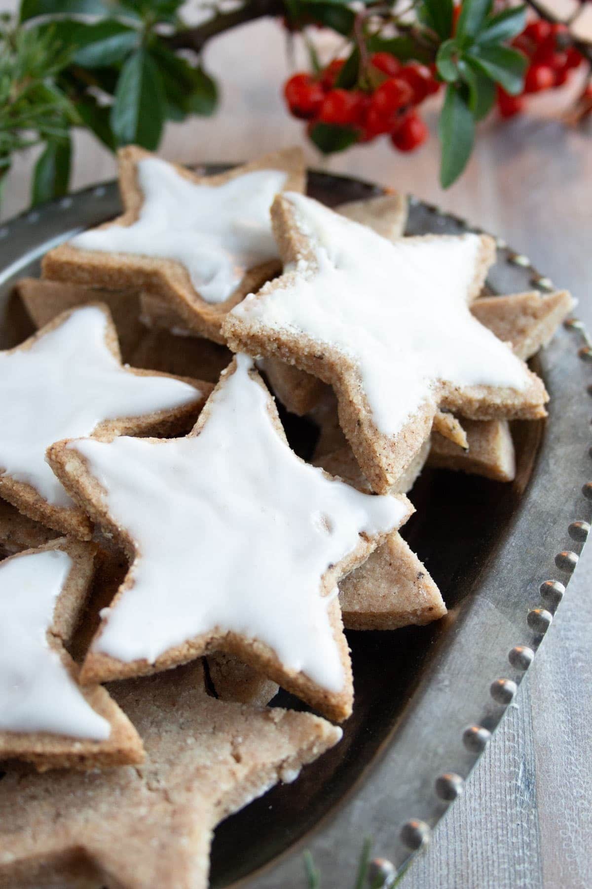 Star shaped cinnamon cookies with sugar icing on top. 