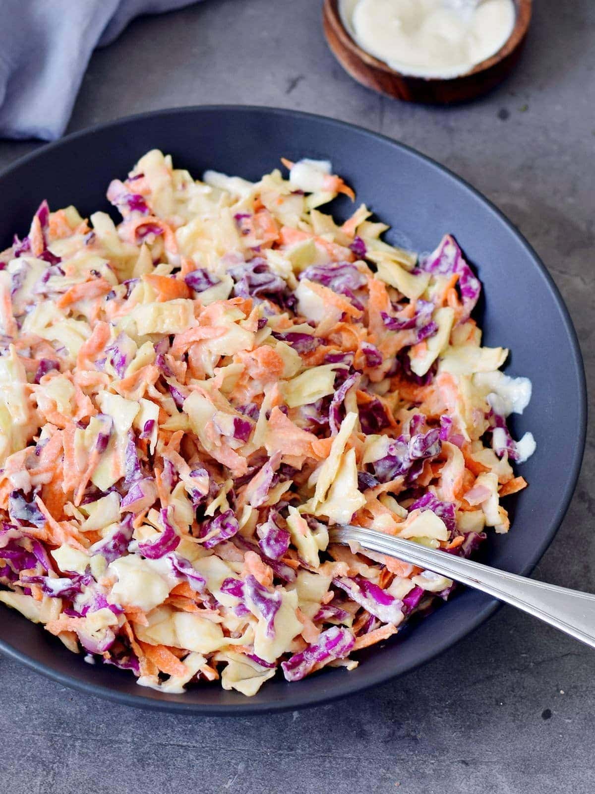 Coleslaw on a plate with spoon.