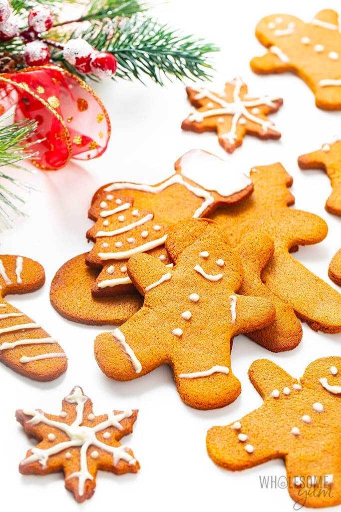 Cutout gingerbread cookies on a white holiday table.