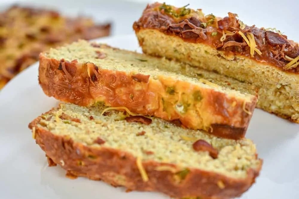 Sliced Jalapeno bacon cheese bread on a white plate.