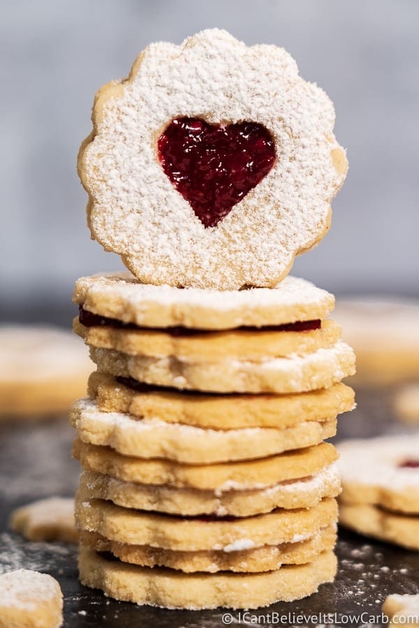 Stack Linzer cookies with red jam filling. 