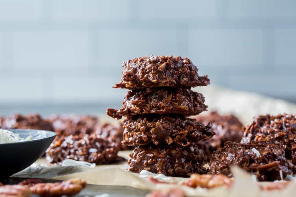Stack chocolate haystack cookies with peanut butter, pecans, and coconut. 