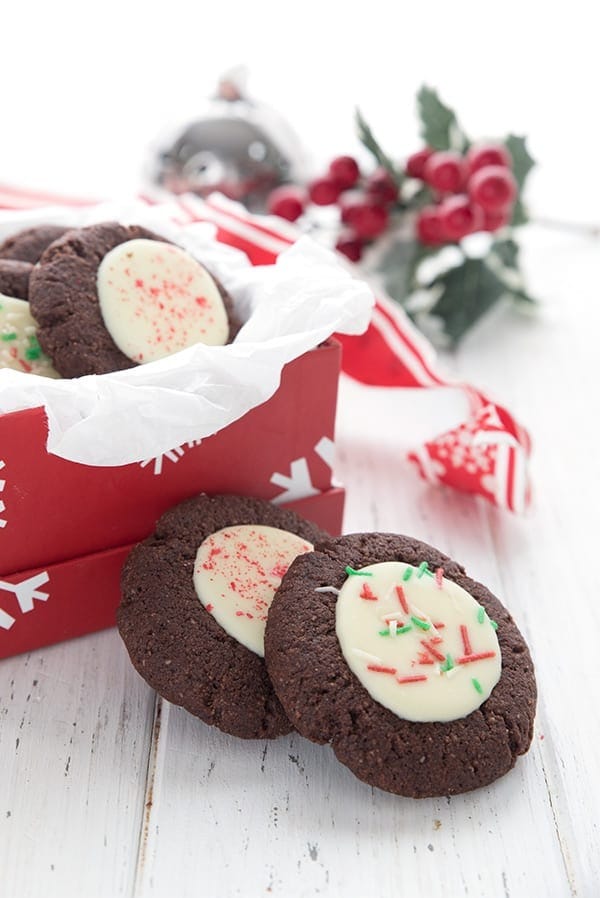 Peppermint bark cookies on a holiday box and table.
