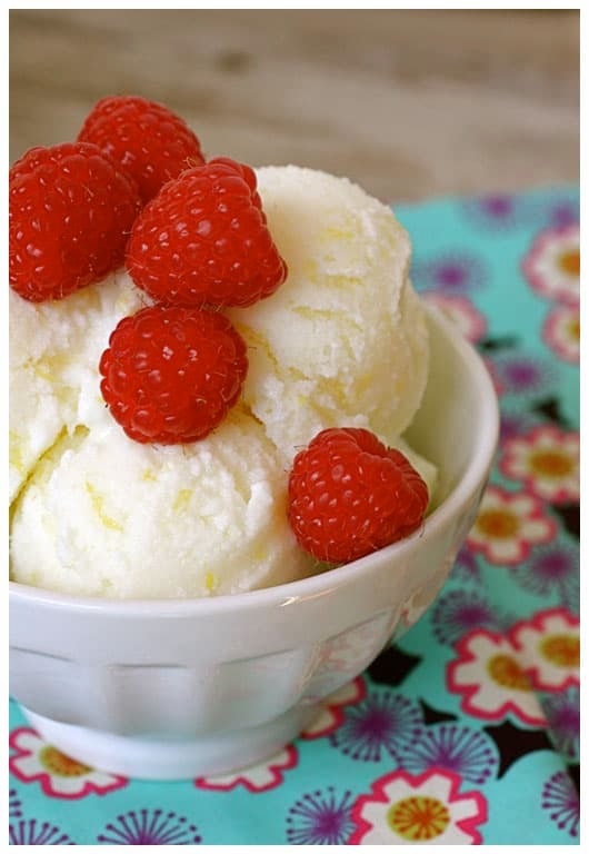 Bowl of sherbet with fresh raspberries on top 