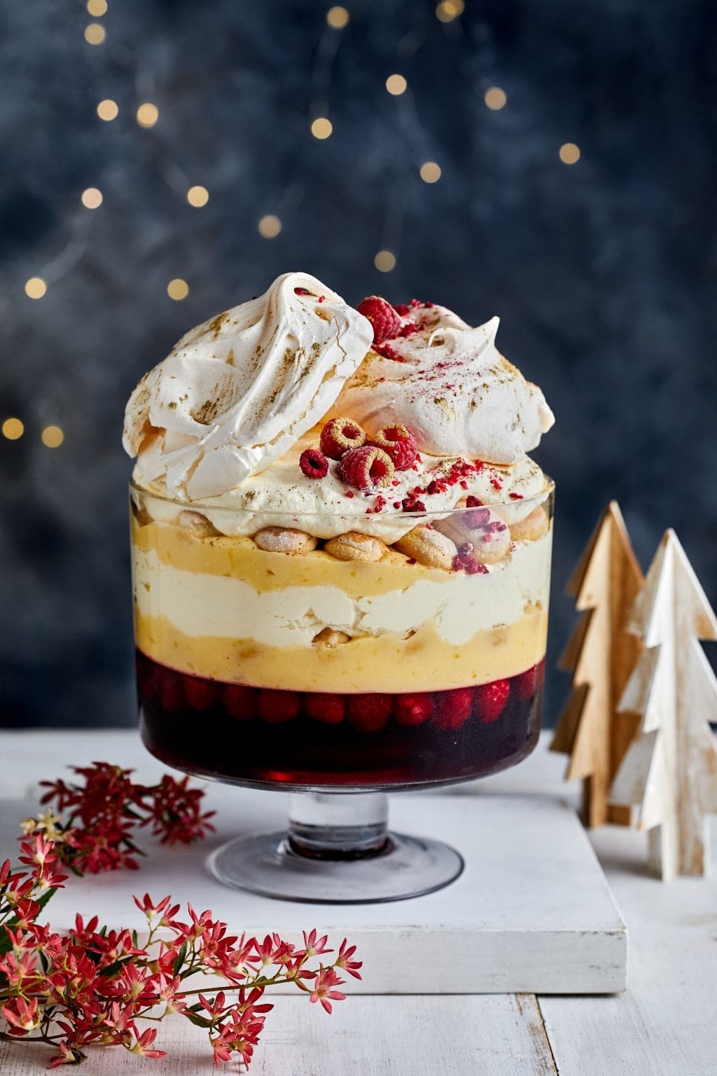 Lemon meringue and berry trifle on a glass trifle bowl. 