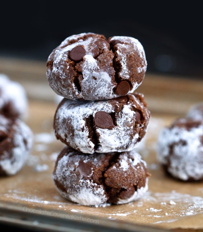 Stack of chocolate cookies covered with powdered sugar. 