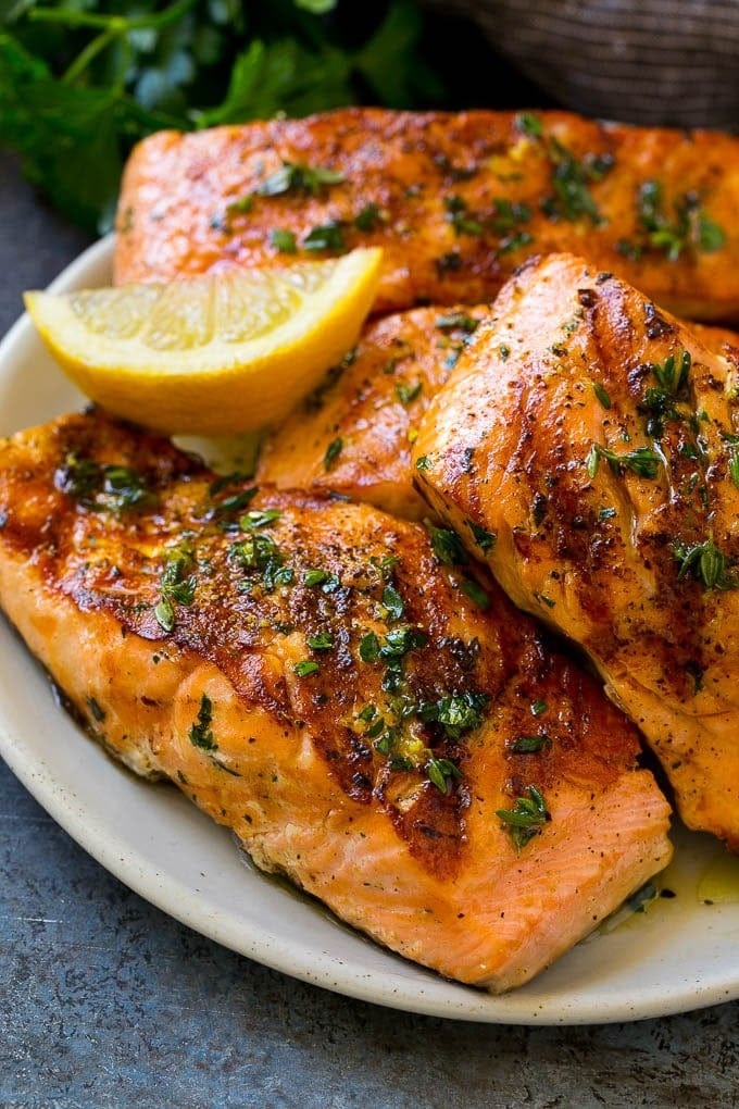 Baked salmon fillets flavored with olive oil, garlic and herbs.