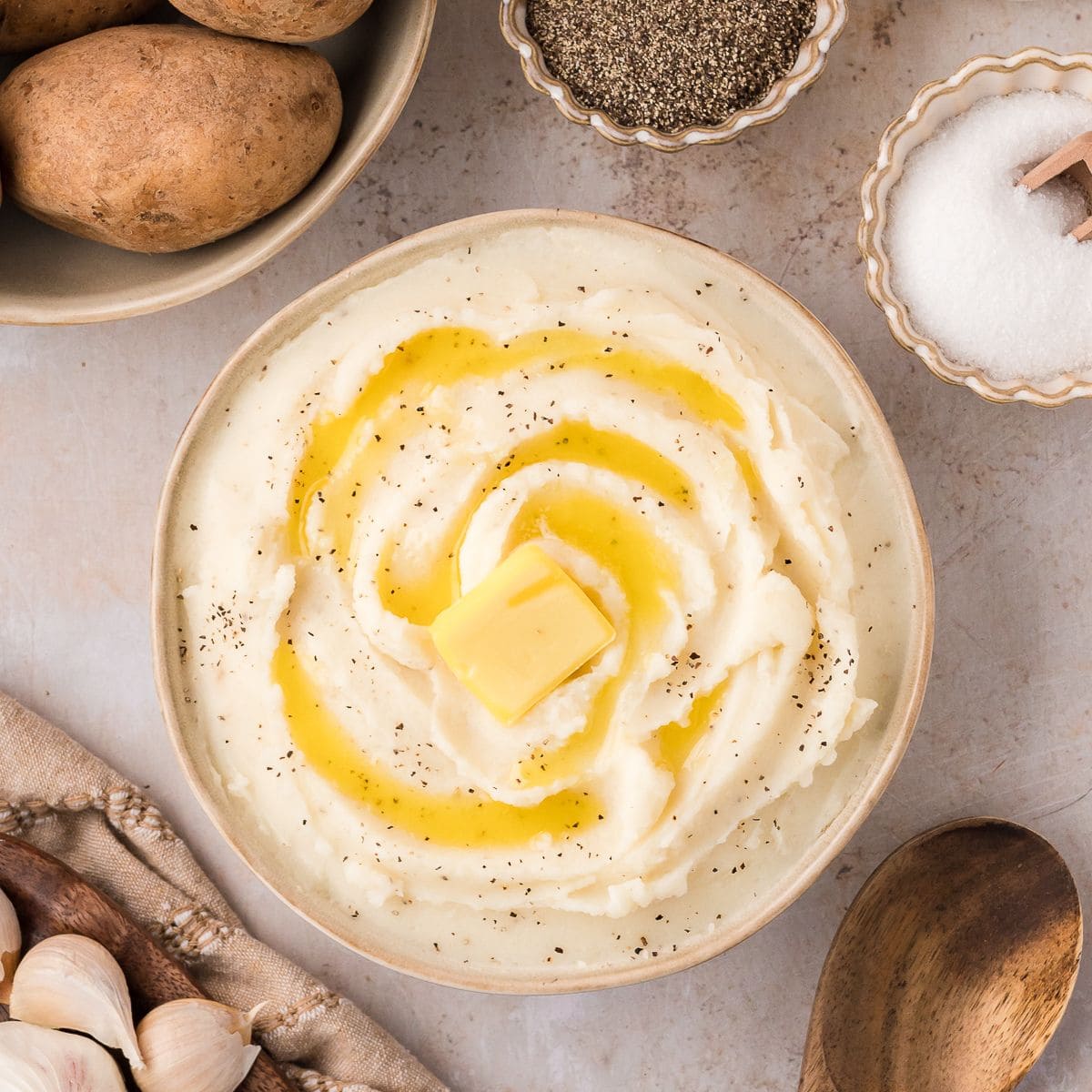 Buttery mashed potatoes in a brown bowl.