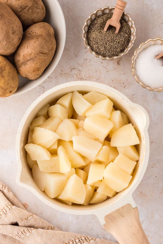 Boiled cube sliced potatoes in a pot.