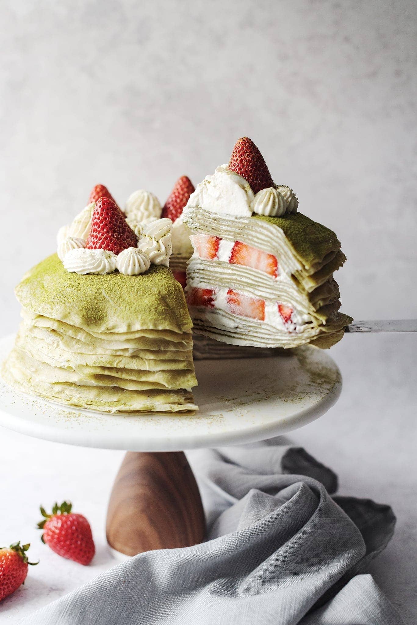 Stack of matcha crepe with strawberry creme filling.