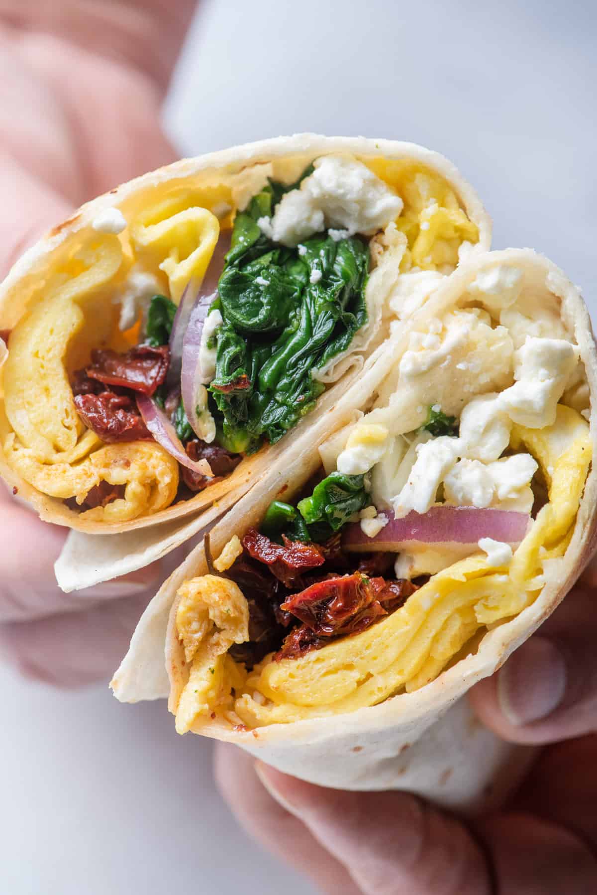 Breakfast egg wraps with sundried tomatoes, onions and spinach