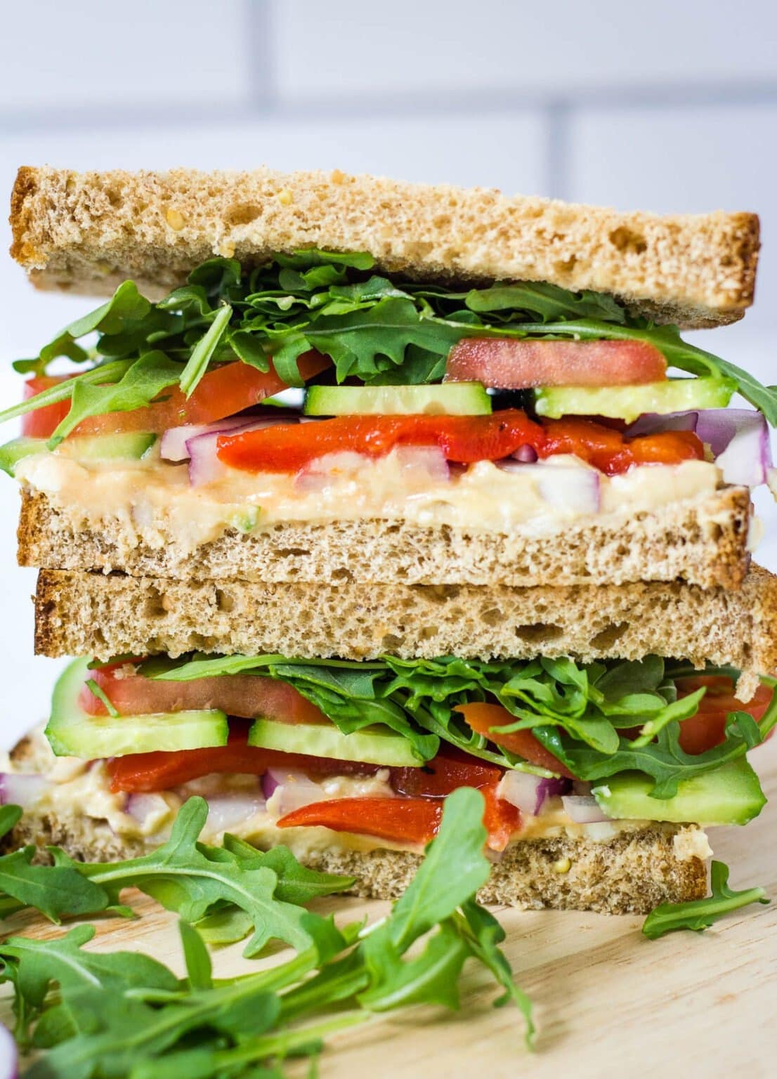 Wheat bread with arugula, hummus and cucumbers filling. 