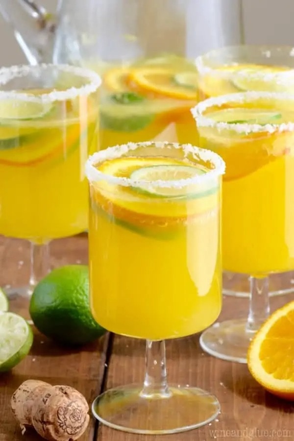 Orange mimosa margarita served in salt-rimmed flute glasses. 