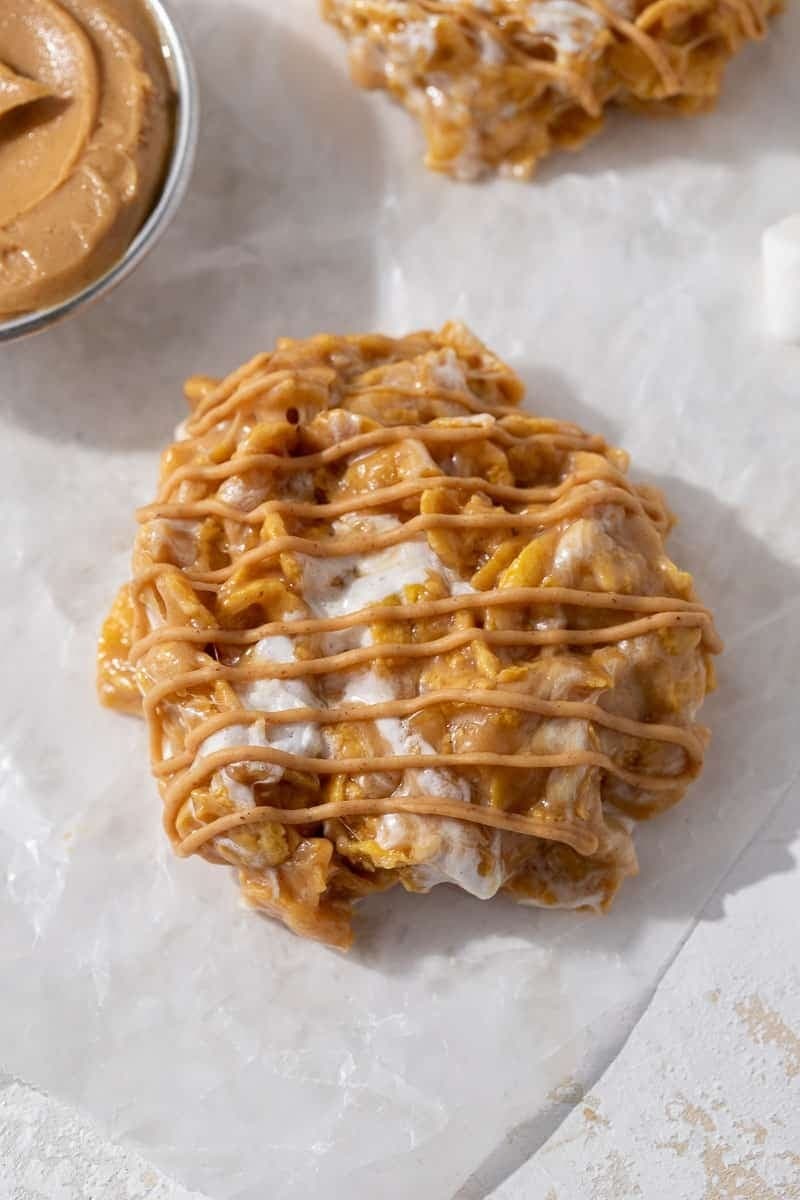 Peanut butter cornflake cookies with marshmallows drizzled with caramel syrup. 