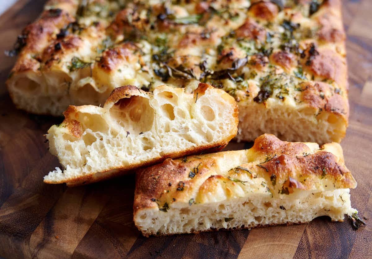 Slices of focaccia bread with garlic butter spread on top. 