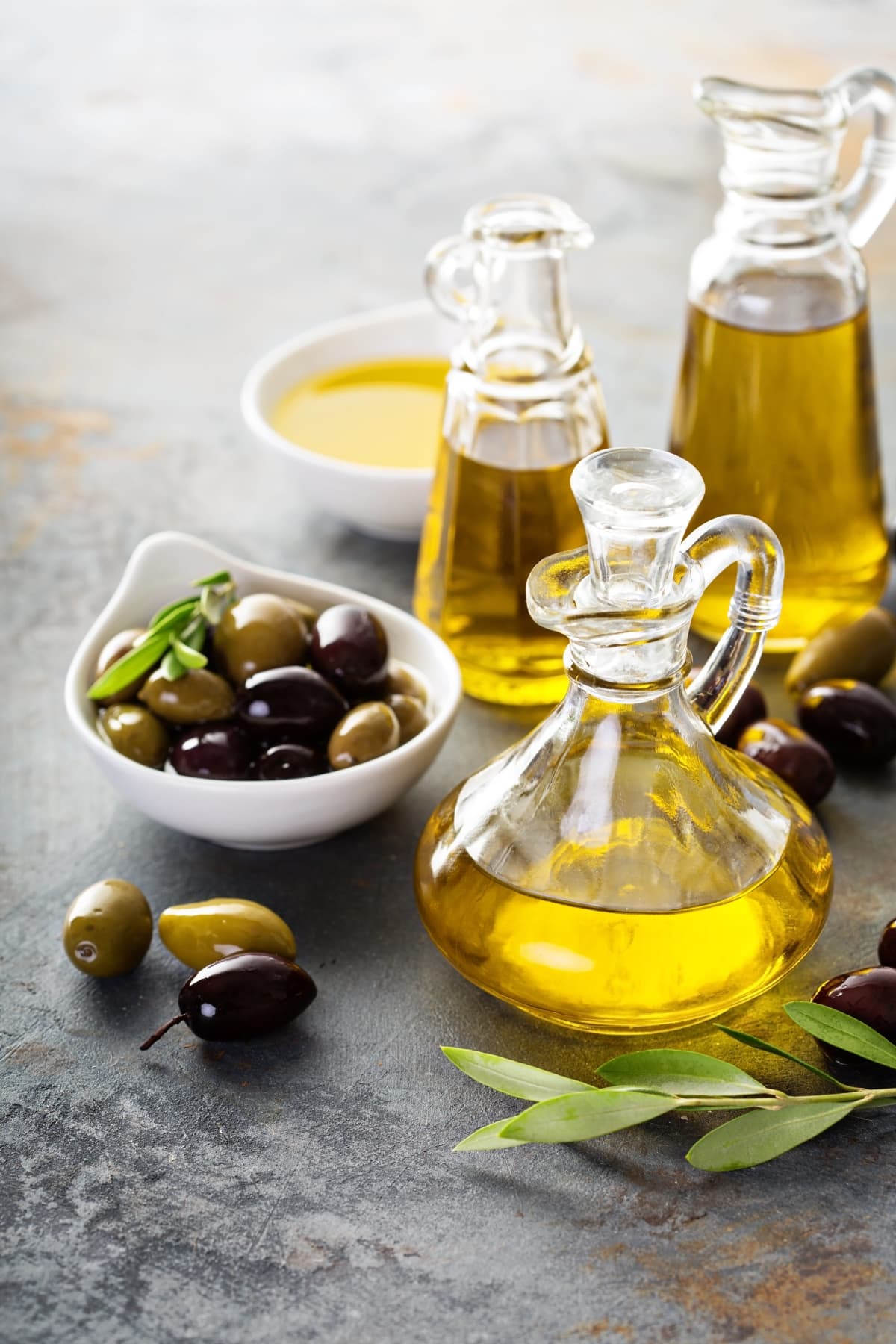 Olive Oil in Vintage Bottles with Fresh Olives in a Bowl